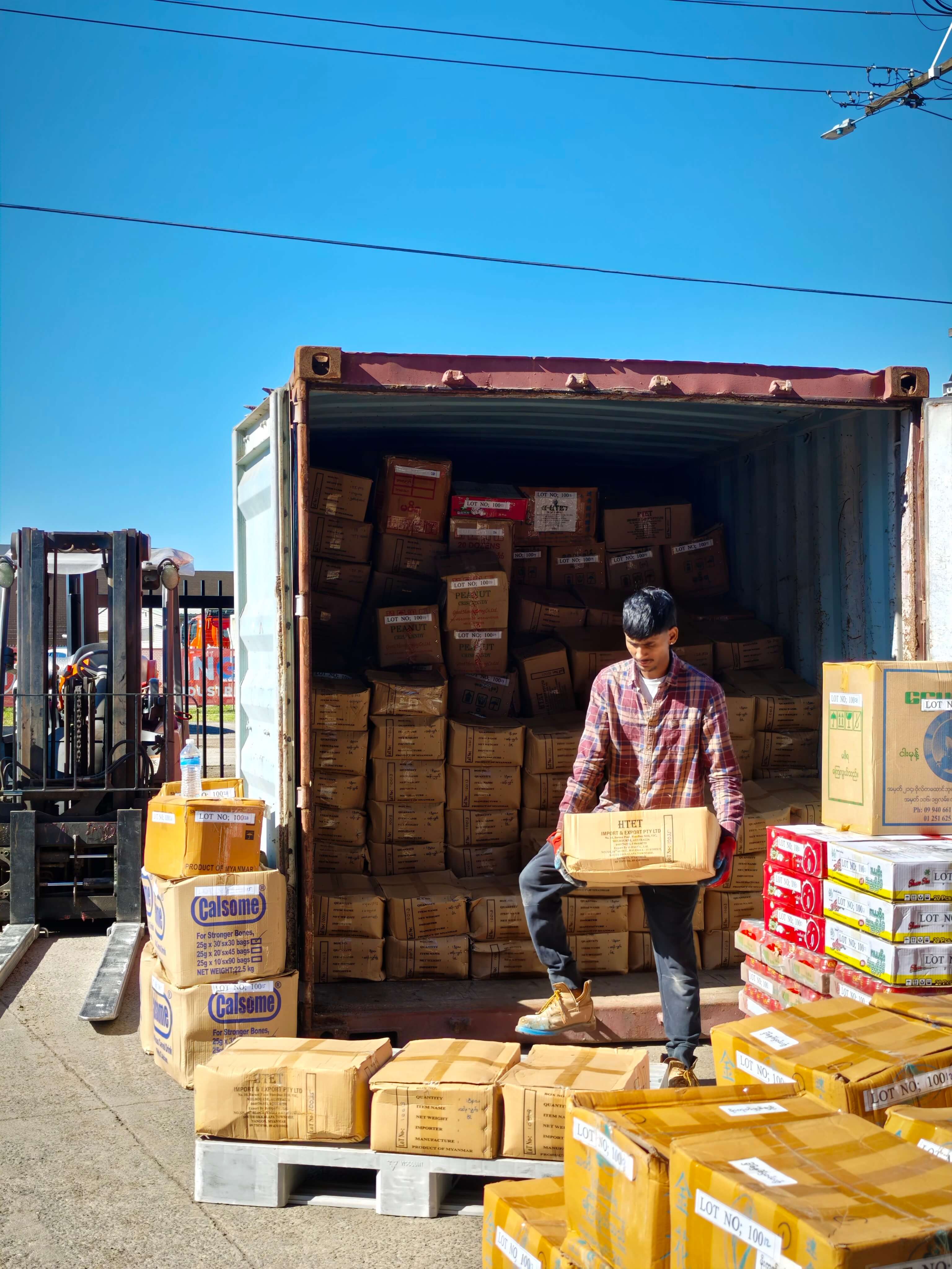 Warehouse team unloading boxes from a container