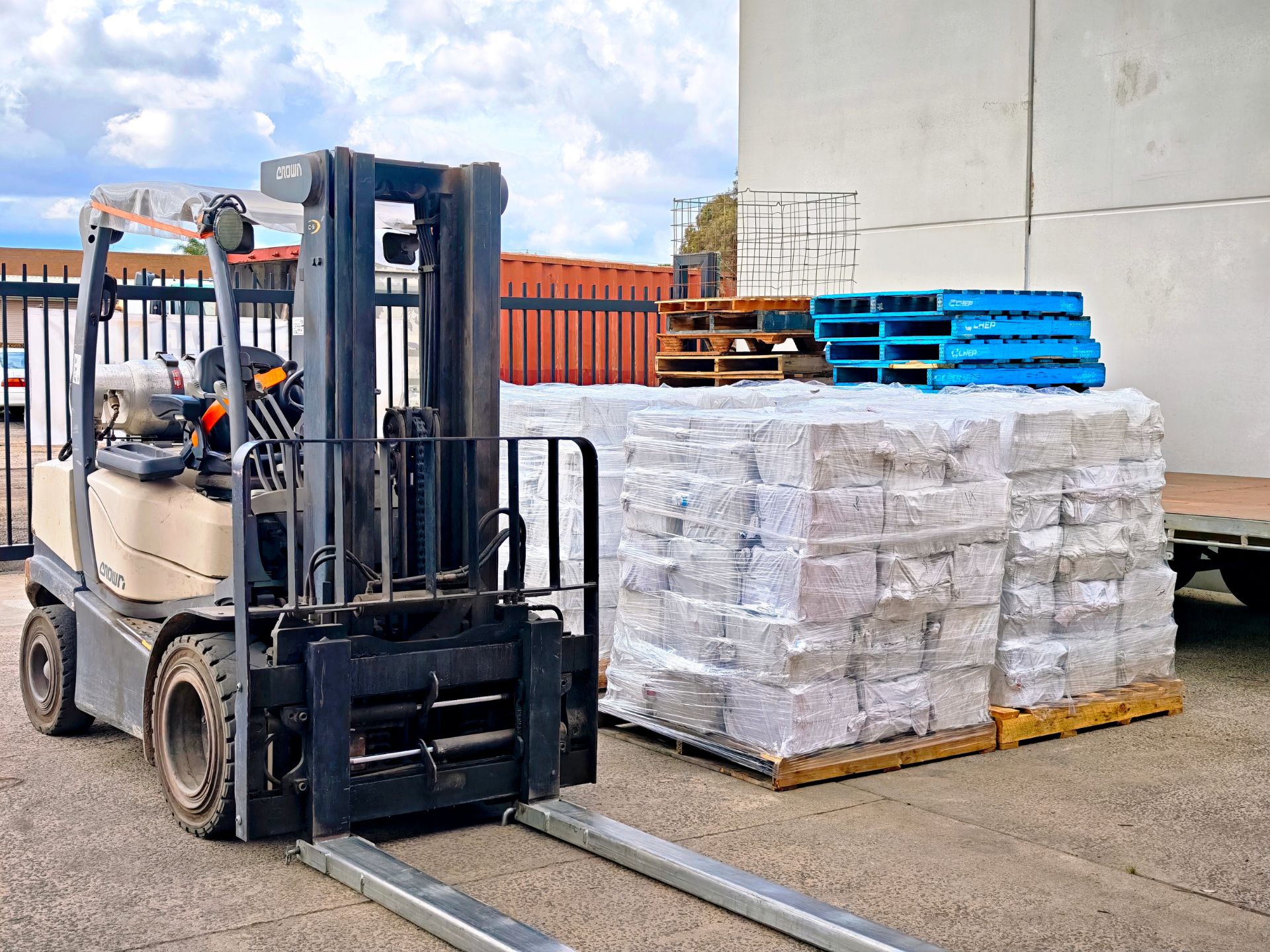 Counterbalance forklift beside palletised stock at MEL1